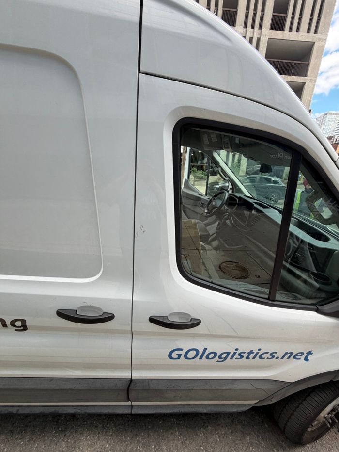 Side view of a white van after the door-access photos