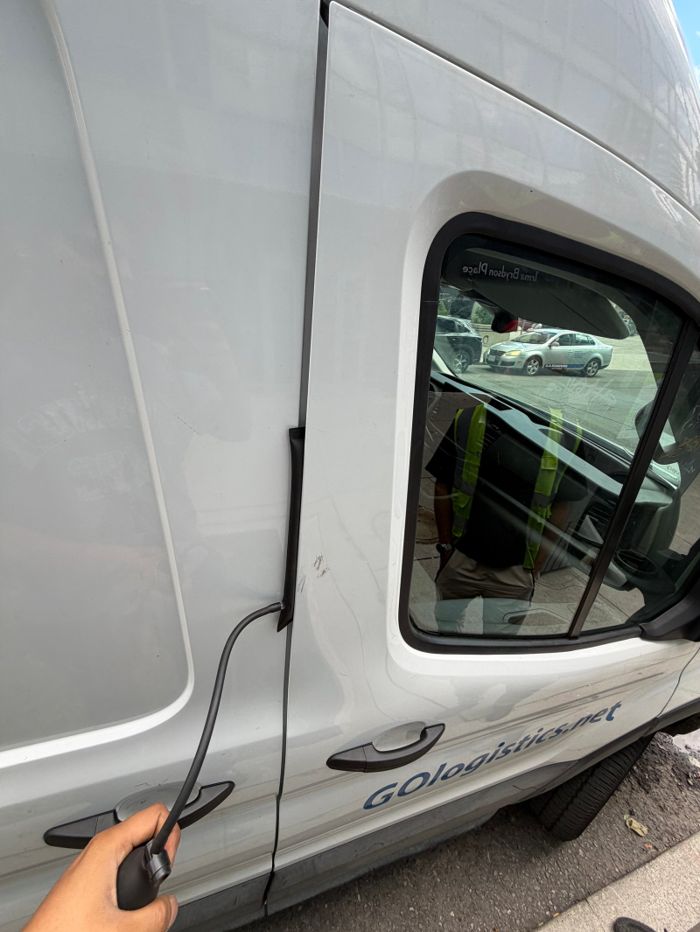 Vehicle access tools positioned at the window of a white van